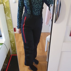 Skidbyxor/Täckbyxor med hängslen storlek 160 - Fina och varma täckbyxor med hängslen och fickor med dragkedjor. Storlek 160 och passar barn/tonåring/liten vuxen.