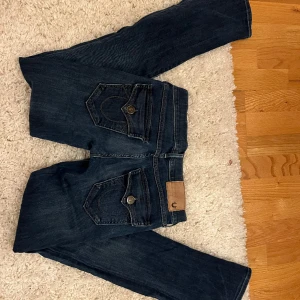 True religion jeans - Super snygga Lågmidjade true religion jeans. Blandning av straight/utsvängda. Storlek 26. Säljer pågrund av att de ej används 