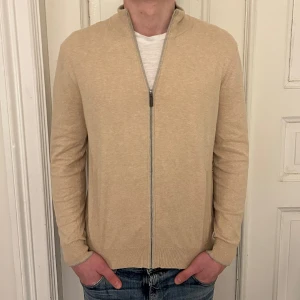 FULLZIP CASHMERE - Säljer denna riktigt sköna fullzip i cashmereblandning från märket Cortefiel. Tröjan är storlek M och helt ny med tags kvar👍Han på bilden är ca 185cm. Hör av er vid frågor eller funderingar!