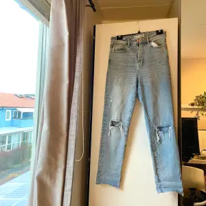 Jeans med små hål vid knäna, storlek 38
