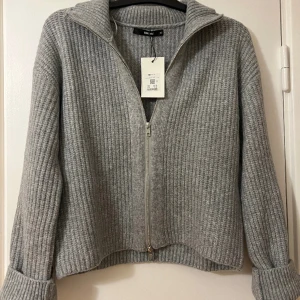 BIKBOK, ribbstickad cardigan - grå stickad tröja/kofta från bikbok i storlek xs, säljer då den är för liten för mig! köptes för 499kr, helt ny, oanvänd, prislapp finns kvar! helt SLUTSÅLD på hemsidan! köparen står för frakten 