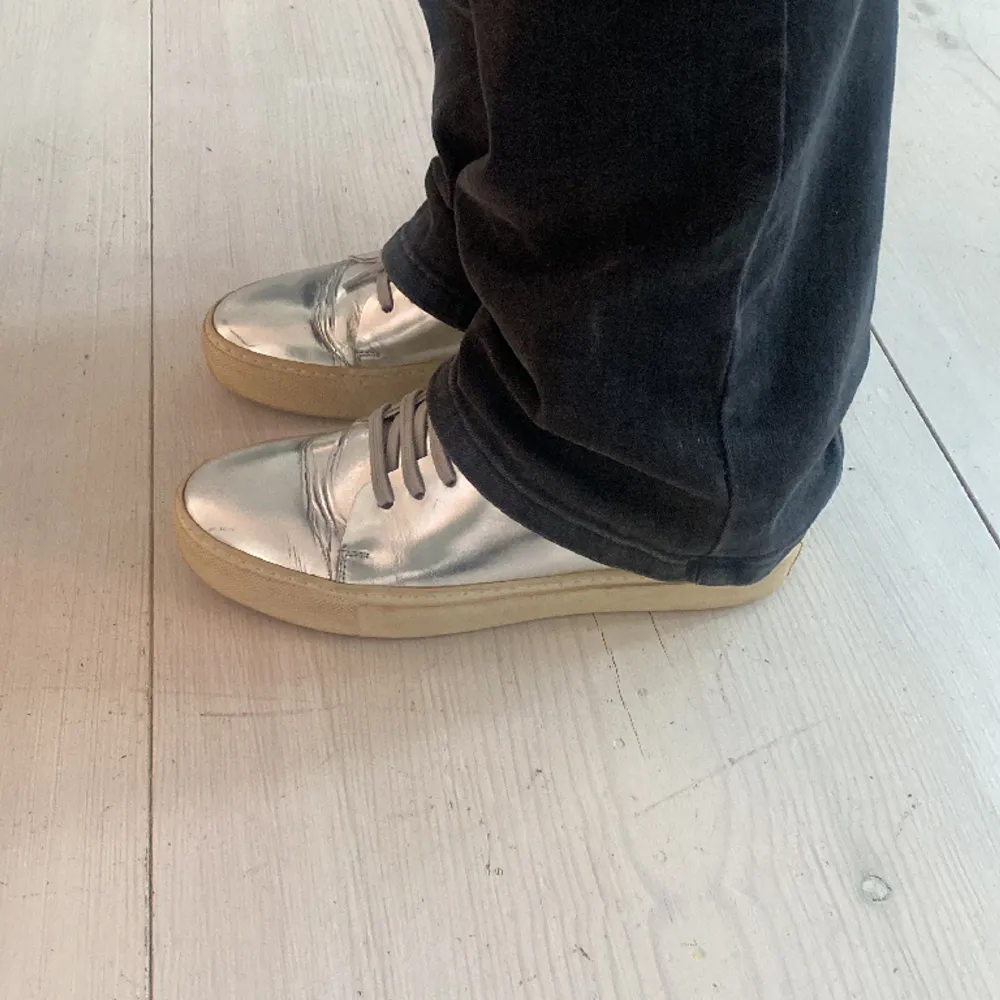 Acne studios sneakers i silver. Skorna är i fint skick, men använda och är i storlek 39. Nypris 3000kr. Skor.