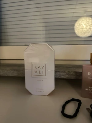 Kayali Vanilla | 28 Eau de Parfum - Kayali Vanilla | 28 Eau de Parfum i en elegant, vit, åttakantig flaska med guldiga detaljer. Doften har noter av vaniljorkidé, tonkaböna, brun socker, amber woods och mysk. Perfekt för dig som älskar söta och varma dofter.