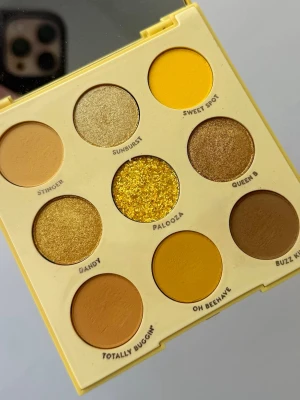 Uh-Huh Honey ögonskuggspalett - Säljer en Uh-Huh Honey ögonskuggspalett från Colourpop med nio nyanser i gult, guld och brunt. Paletten innehåller både matta, skimriga och en glittrig skugga. Förpackningen är gul plast med spegel på insidan och paletten är kompakt och enkel att ta med. Några skuggor använda nån enstaka gång. 