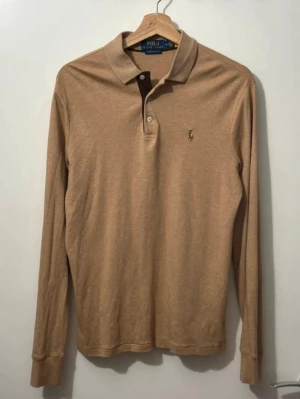 Polo Ralph Lauren Beige Polo Tröja - Polo Ralph Lauren Beige Custom Slim Fit Soft Cotton Polo Tröja. I nyskick utan defekt. Storlek M. Nypris är ca 1600 kr. Skickar alltid samma dag eller nästa dag. Skriv för mer information eller frågor.