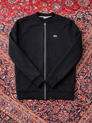 Svart lacoste zip kofta - Snygg stilren lacoste zip kofta. Kan diskutera pris vid snabb affär våga lägga ett bud!🫰🏼