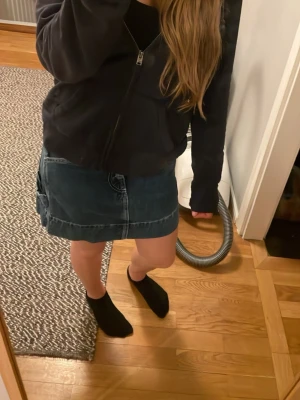 Blå jeanskjol - Säljer en blå jeanskjol i klassisk modell med stora bakfickor och markerade sömmar. Skulle säga att den är rätt så tajt i midjan!