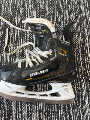Bauer M5 pro skates svart/gul - Säljer ett par svarta och gula Bauer m5 pro skridskor med vita snören och vita Tuuk-stålblad. Skridskorna har en sportig design med detaljer i gult och silver, samt robust yttermaterial och vadderad plös för extra komfort.
