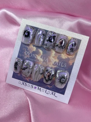 LunaKook (M);Short Ballerina - Handgjorda press-on naglar i lila med silverdetaljer och  motiv av JK (BTS) samt motiv av sol, måne och stjärnor. Naglarna har en blank finish och kort längd i ballerinaform, perfekt för dig som vill ha något unikt och kreativt.M: 16 mm, 12 mm, 12,5 mm, 11,5 mm, 10 mm