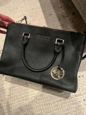 Michael Kors Väska - Jätte fin väska! Kommer inte till användning. Har axelband som går att ta av, samt handtag ifall du vill ha en handväska. 