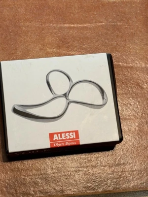 Alessi Spaghettimått - Alessi spaghettimått i rostfritt stål. Helt nytt. Mäter 1, 2 eller 5 portioner spagetti. Nypris 329 kr.  Alessi spaghetti measurer in stainless steel. Brand new. Measures 1, 2, or 5 portions of spaghetti. Original price 329 SEK