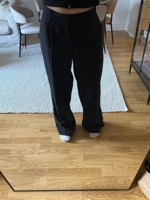 Svarta kostymbyxor Gina Tricot - Säljer ett par svarta kostymbyxor från Gina Tricot med rak och vid passform. 