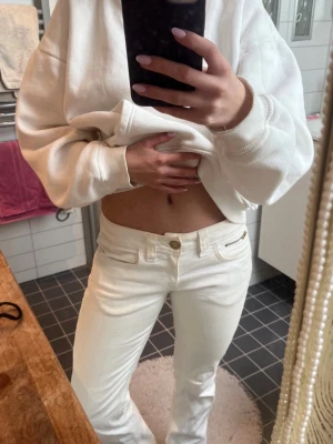 Vita raka jeans från crocker  - Säljer ett par vita jeans  med raka ben och låg midja. Jeansen har klassiska fickor fram och bak, samt en snygg detalj med dragkedja på bakfickan. Perfekta för en clean och trendig look.