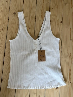 Vit topp urringning - Säljer denna super söt vit uringad topp från Sellpy💓 kom tyvärr aldrig till användning!