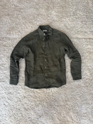 Grön Linneskjorta Herr - Riktig fet mörkgrön linneskjorta från uniqlo. Perfekt nu inför sommaren så passa på innan den säljs! Storleken är XS men som alla vet blir linneskjortor större när man använder dem, så skulle säga att dem passar S. Skriv gärna om ni har några frågor eller behöver mått på plagget!💬✍️