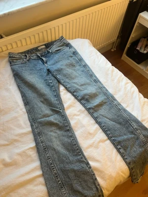 Blå bootcut jeans  - Säljer ett par klassiska blå bootcut jeans från Gina Tricot. Jeansen har en låg midja med snygga detaljer på bakfickorna. Använda ett fåtal gånger skriv för fler bilder💕