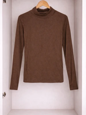 Brun polotopp med lång ärm - Mjuk och enkel brun polotopp med lång ärm. Toppen har en klassisk polokrage och är figurnära i modellen, perfekt att styla med jeans eller kjol. Tillverkad i ett stretchigt material som känns bekvämt mot huden.