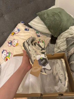 Asic gel nyc oyster gray - Snygga sneakers från Asics i beige och grå toner med meshpaneler och detaljer i syntet. Skorna har klassisk snörning och en chunky sula för extra komfort. Perfekta för dig som gillar stilrena och sportiga sneakers.helt nya