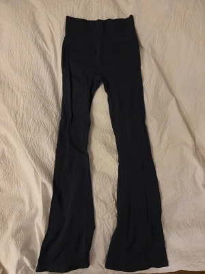 Svarta ribbade bootcut leggings - Säljer ett par svarta träningsleggings med ribbad struktur och utsvängda ben. Stretchigt material som sitter skönt. Använd fåtal gånger🤗