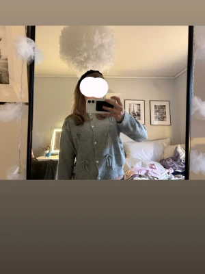 Grå kofta med rosetter och pärlknappar - Säljer en stickad grå kofta med rosetter ifrån Luna Ivy  ( köpt i usa) strl xs men passar även som s💞💞