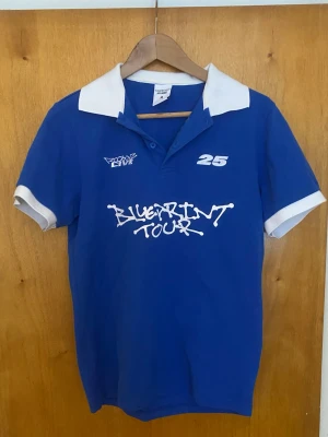 Blå pikétröja från Rocboyz - Blå pikétröja från Rocboyz från deras konsert i Stockholm sent förra året. M i storlek aldrig använd