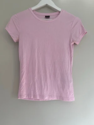 Ljusrosa basic tight t-shirt - Ljusrosa tight t-shirt ifrån gina tricot i storlek S
