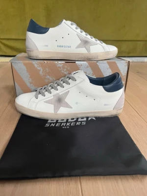 Golden goose GGDB super-star slot - Tjena!! Säljer nu dessa extremt feta och eftertraktade Golden Goose super-star skor i vit och marinblå färg!! Skriv vid frågor och funderingar!!