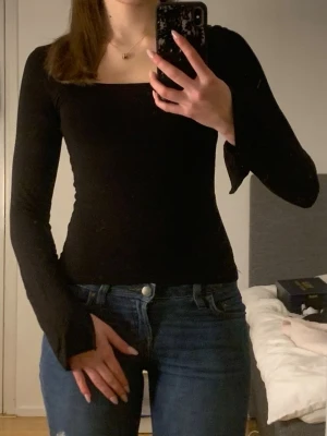 Helt ny oanvänd svart långärmad topp med urringning  - Säljer en svart, tight topp med långa ärmar och urringning. Går även att styla som off shoulder topp och fler andra sätt. Toppen har en stilren, enkel design och sitter figurnära. Säljer den då den aldrig kommit till användning, endast provat i butik. Kontakta mig om ni undrar något💗