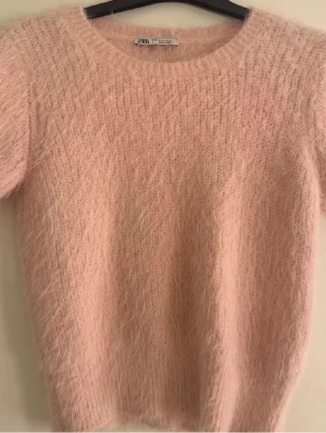 Ljusrosa stickad tröja - Supersöt ljusrosa stickad tröja från Zara, säljer då jag inte har användning för den längre! Storlek M men passar mig som brukar ha XS-S💕går bra att köpa nu.