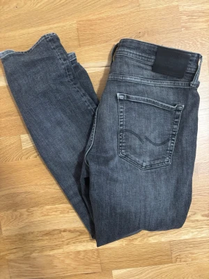 Gråa Jeans Jack&Jones - Säljer ett par grå svarta Jack&Jones Jeans i storlek 34/32. Passformen är Tapered/Mike, Jeansen säljs inte längre på Jack&Jones vilket gör det svårt att få tag på dem. Original pris ligger på runt 700-1000kr.
