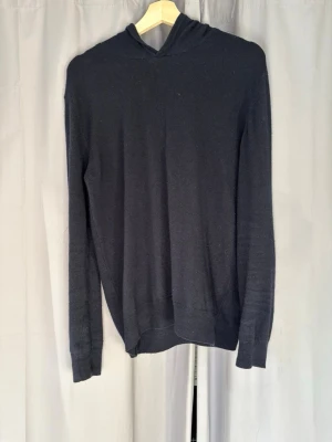 Mörkblå hoodie i cashmere - En fet mörkblå Hoodie från Oscar Jacobsson. Material i hundra procent cashmere. Perfekt nu till våren elelr sena sommarkvällar. Först till kvarn