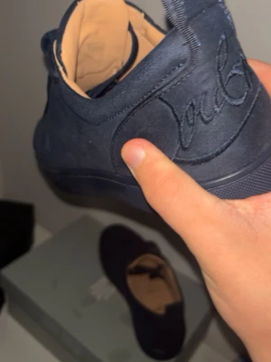 Louboutin navy 43 - Säljer nu mina loubs som varit mina go-to skor i ett år. Skorna är i gott skick men det finns en liten defekt på bild 3 på den vänstra skon. Mockan är i mycket gott skick och defekten är ingenting man märker av när man har på sig de. Lådan tillkommer vid köp! Vid frågor svarar jag gärna i dm. 