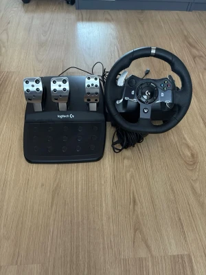 Logitech G920 ratt och pedaler - Logitech G920 racerratt och pedalset för Xbox och PC. Ratten har svart konstläder, metallspakar och knappar, medan pedalerna är i borstat stål och svart plast. Perfekt för realistisk racingkänsla hemma.Ingår: • Strömkabeln • Ratten • Pedalerna  • växel spak (250kr extra) Allt är i strålande skick använt kanske 2-3 gånger går även att köpa en växel spak som jag har till den för 250kr extra annars kan man ju såklart nöja sig med ratten och pedalerna skicka om ni vill ha mer bilder eller frågor ell