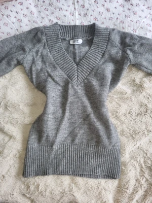 Grå stickad tröja med v-ringning - Super söt tröja, inga defekter, går att knyta bak i midjan, köpt från yesstyle.        