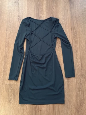 Grönblå klänning med detaljer i ryggen - Väldigt fint skick! Stl M