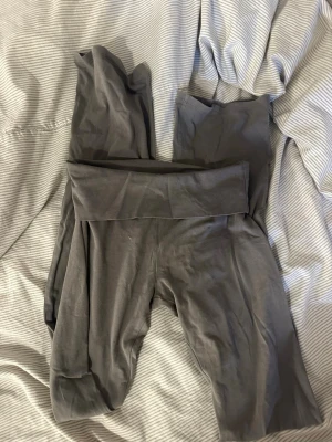 Grå leggings från Nelly XS - Mörkgrå yoga pants  från Nelly med stretchigt material. Perfekta för en avslappnad stil eller till träning. Mjuka och bekväma med enkel design utan synliga detaljer.