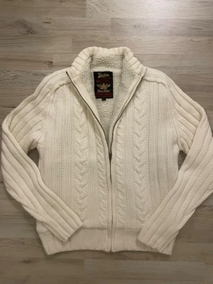 Fodrad stickad cardigan - Otroligt fin vit fodrad stickad cardigan med fint mönster. Passar perfekt till kallare väder. Priset kan såklart diskuteras! Storlek M men sitter mindre som en S