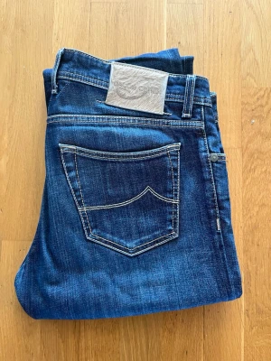 Blå jeans från Jacob Cohen - Snygga blå jeans från Jacob Cohen i strl 35! Nästan som nya förutom pyttesmå defekter på patchen där bak!