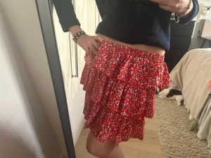 Trendig vårkjol! - En trendig vårkjol i ett vackert rött mönster med inslag av blått vitt och svart! Älskar denna och passar till både våren och sommaren. 