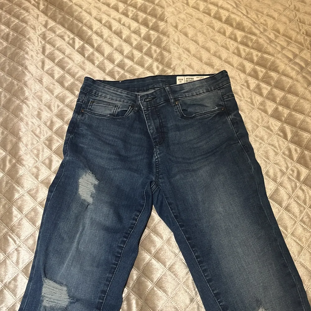 Mörkblåa jeans med hål i. Bekväma och inte för högmidjade och inte för lågmidjade. . Jeans & Byxor.