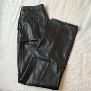 PU-byxor - Byxor i PU med stråveck fram och bak från nakd, använda fåtal gånger. Storlek 32, lite oversized i modellen. Nypris 599kr.