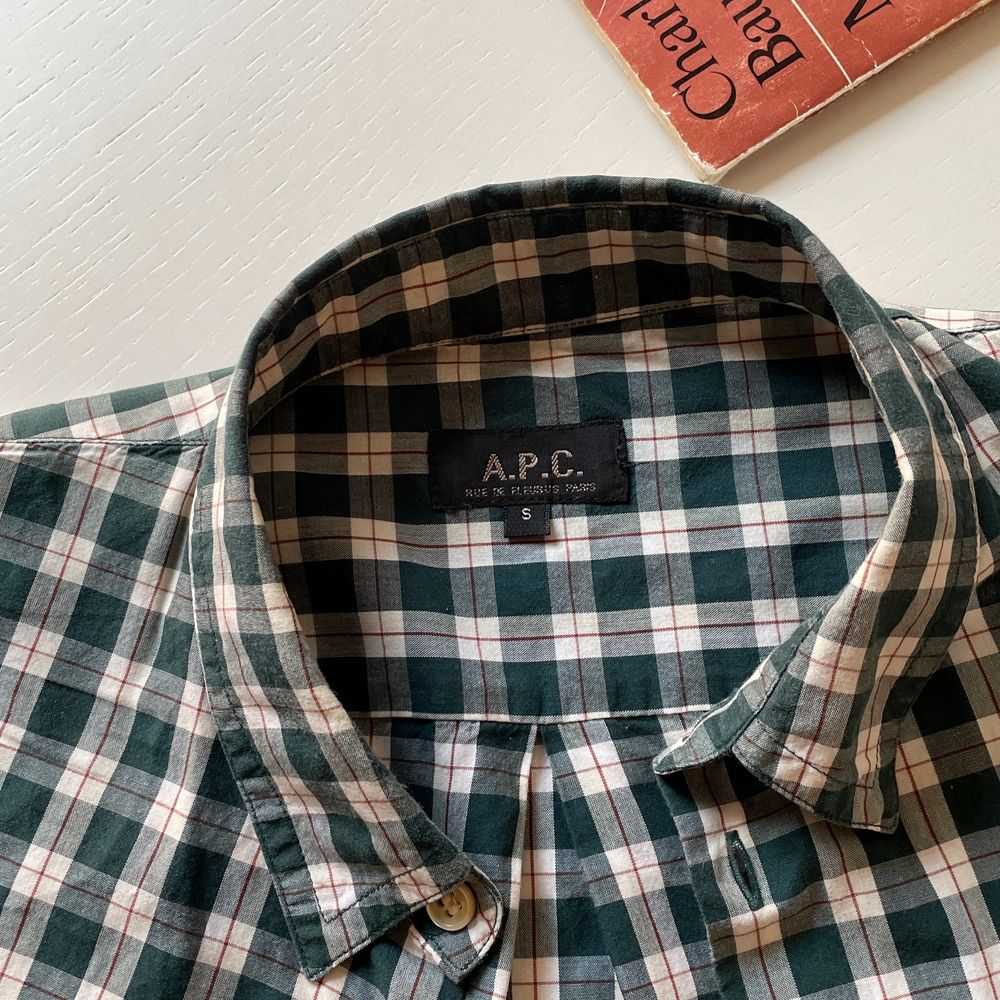 Ca. 2010 forest green tartan shirt with folded sleeves held up with a buttoned strap. Mens size S but fits like XS. Sparingly used, but there is an 8mm tear by the 3rd button from the top. Not visible and easily fixed.. Skjortor.