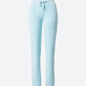 Juicy byxor - Säljer mina ljusblåa juicy byxor då jag aldrig använder dem mer. Dem är uppsydda lite, jag är 165 och dem når ned till marken. Köparen står för frakten🥰