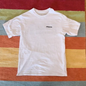 Patagonia T-shirt  - En vit patagonia T-shirt i extra small regalur fit. Tröjan är knappt använd och hade ordinarie pris på ca 350! Tröjan är dock mycket större än en XS, mer åt S hållet om du frågar mig! 