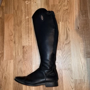 Ridstövlar dam - Säljer mina ”Arezzo” ridstövlar som är inköpta på hööks. I använt skick men fortfarande jättefina, och framförallt sköna!  Höjd på skaftet ca 50cm och storlek 39.
