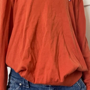 Tommy Hilfiger tröja orange - Köpt second han men är från Tommy Hilfiger, bra skick, jag har använt den några gånger men känner inte att jag har användning av den längre 