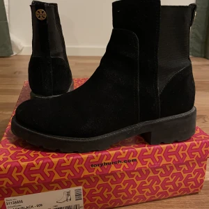 Varmfodrad sko Tory Burch - Svart varmfodrad Curlingsko i mocka, Tory Burch, Storlek 39,5 (8,5 US) och stor i storlekn. Använd ett fåtal gånger, bra skick. 