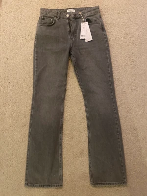 Full length flare Jeans - Helt oanvända jeans från Gina Tricot, jättefin grå färg, medium längd i midjan och extra långa, säljs för 200kr  