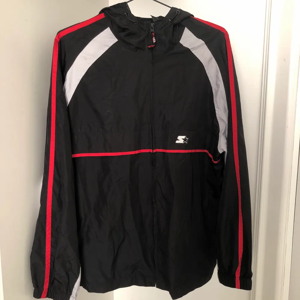 Black shell jacket with hood with red and light grey parts. It’s in very good condition, I bought it second hand myself and barely used it, hopefully it finds a new owner that has more use for it :). Jackor.
