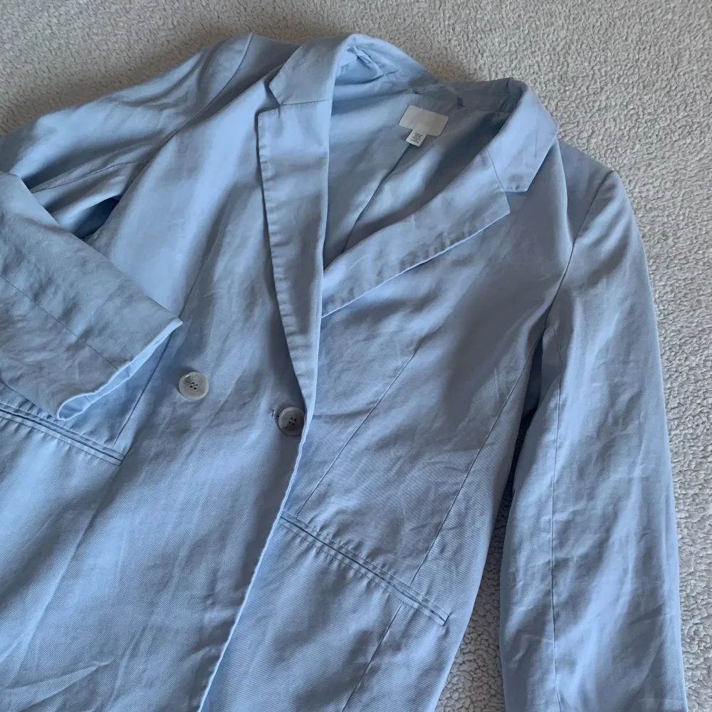 Superduperfin ljusblå kavaj från H&M. Snygg oversize modell, och en perfekt vardagskavaj nu till våren 🌻 Passar så väl som till jeans som till klänning. Otroligt skönt och luftigt tyg. Fint skick, men behöver strykas. Material: Viscose och polyester. 🌻. Kostymer.